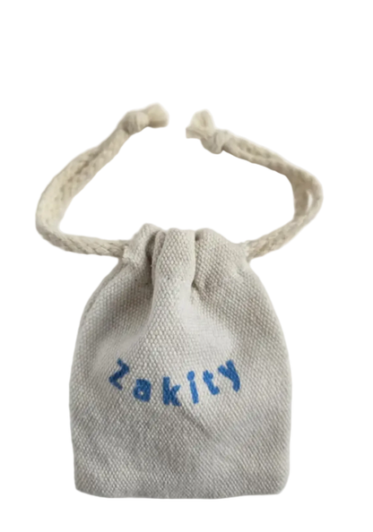 A small beige woven drawstring pouch with the word 'Zakity' embroidered in blue across the front, shown on a plain white background.