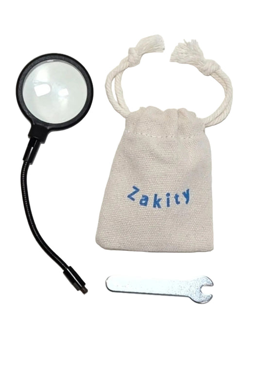 Zakity adjustable magnifying glass with canvas protective bag and metal tightening tool displayed on a white background.